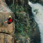 Woman Rocking Climbing Near Waterfalls